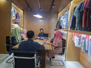 Apparel design team meeting discussing fabric swatches and new collections in a modern office.