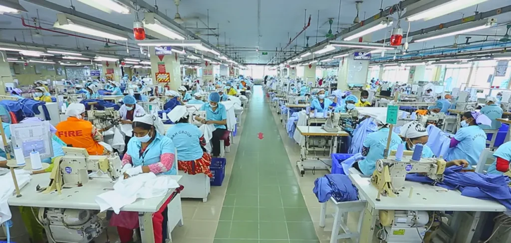 Sewing operators working on a busy production line inside a Bangladesh ready-made garment factory.