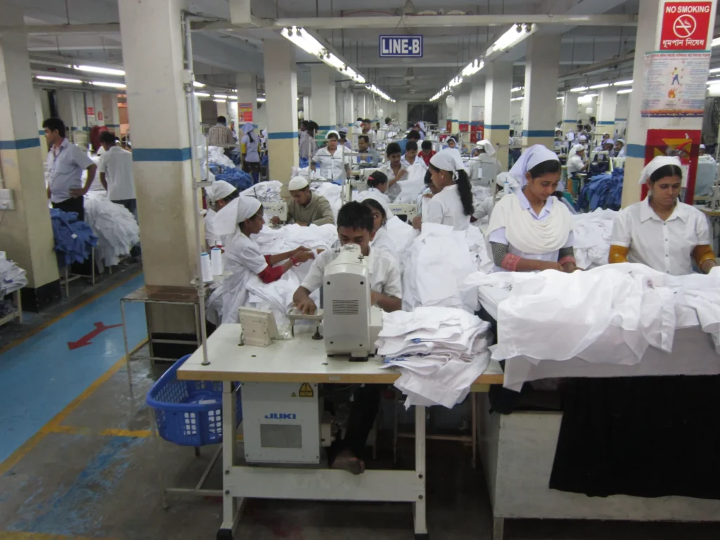 Sewing operators working on a woven shirt production line in a Bangladesh garment factory