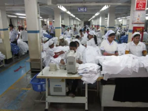 Sewing operators working on a woven shirt production line in a Bangladesh garment factory